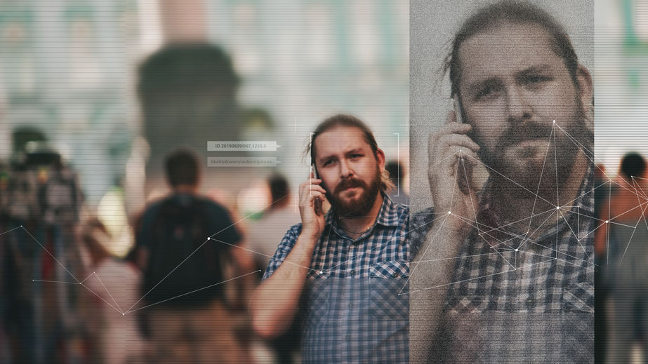 Facial recognition and search and surveillance of a person in the modern digital age, the concept. man with phone in crowd of people on the street, identification and modern technology